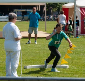 Evie participating in the shot put and wining £10 prize money. 